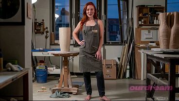 Curvy Redhead Sculptor Pleased Against Her Studio Stand